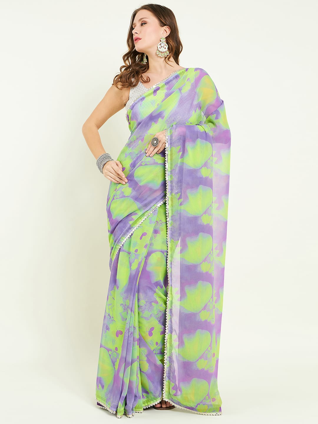 Digital printed floral saree embellished with lace detail comes with contras blouse and lace detailing on border.