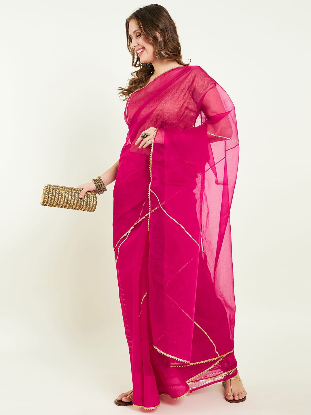 Organza saree with gota lace detailing on saree comes with heavy gota blouse.