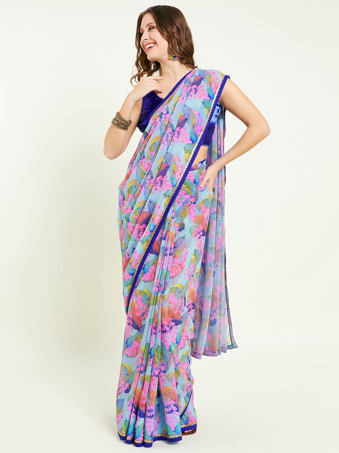 Digital printed floral saree embellished with lace detail comes with contras blouse and lace detailing on border.