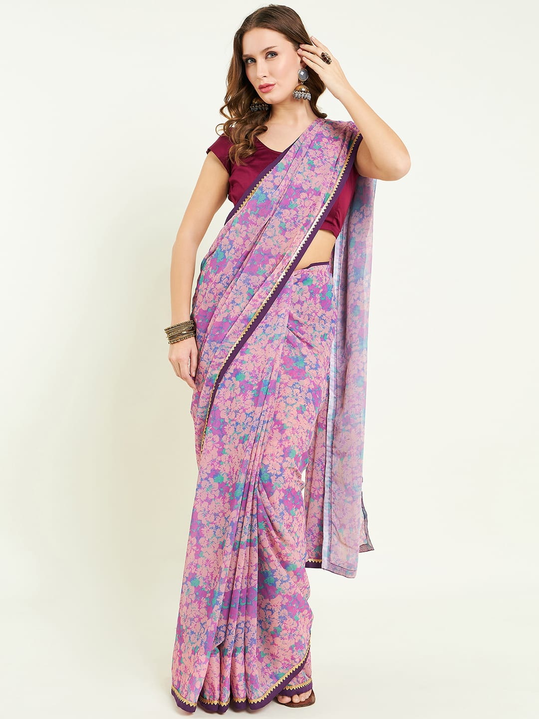 Floral printed saree with contrast border with lace detailing comes with solid blouse.