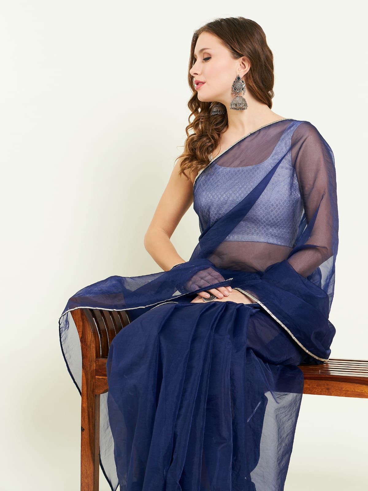 Organza sari comes with contrast lace detailing on border and blouse.