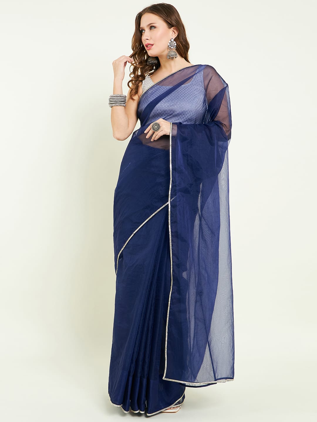 Organza sari comes with contrast lace detailing on border and blouse.